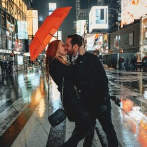 Image of a girl and boy kissing in center of street over it romantic love status in written